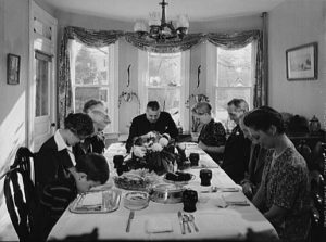 The little girl says the dinner blessing